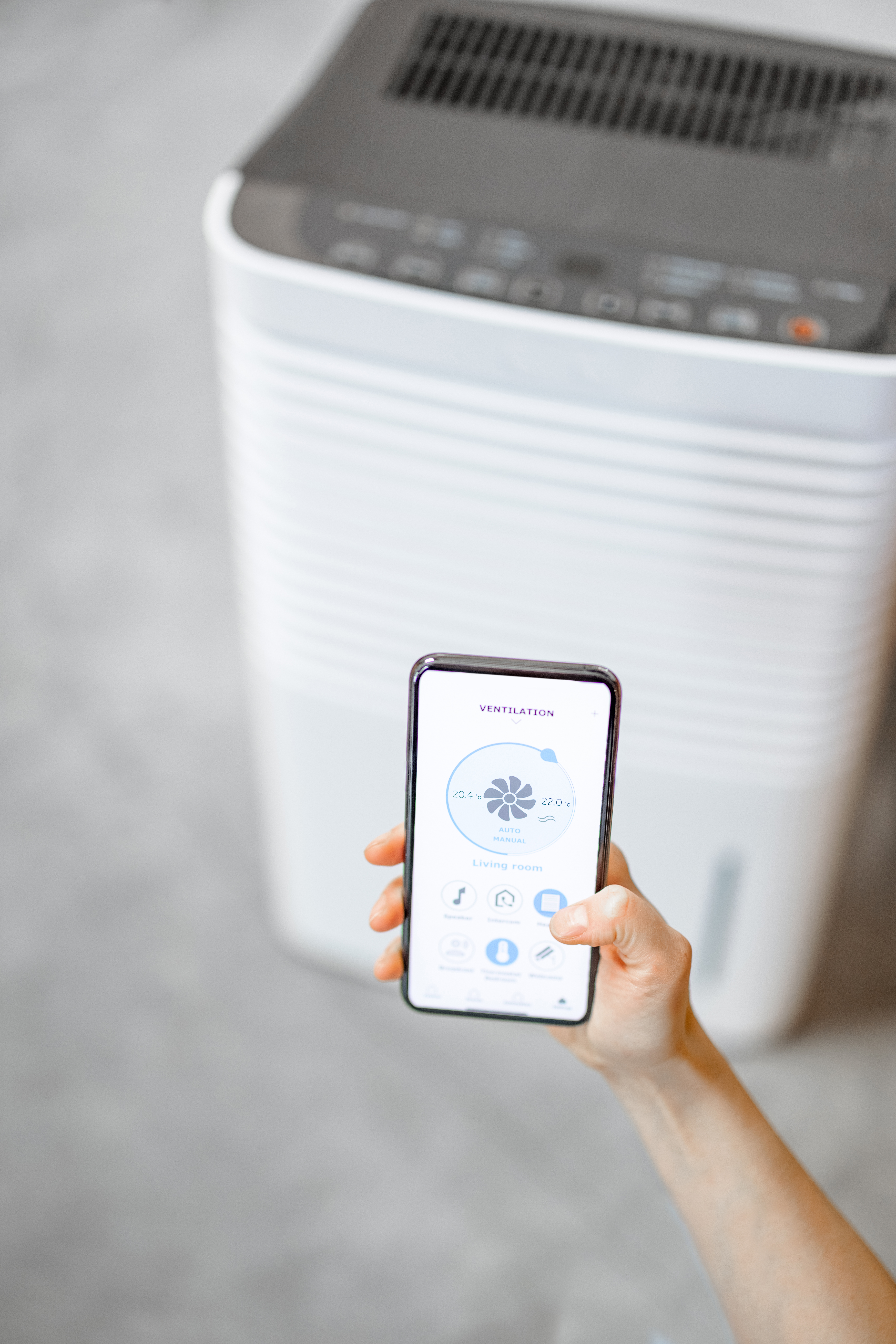 Smartphone with launched application for for ventilation adjustment, air quality monitoring. Health microclimate at home concept.